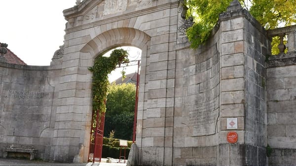 The stone arched gateway to the Maison des Lumières Denis Diderot is pictured